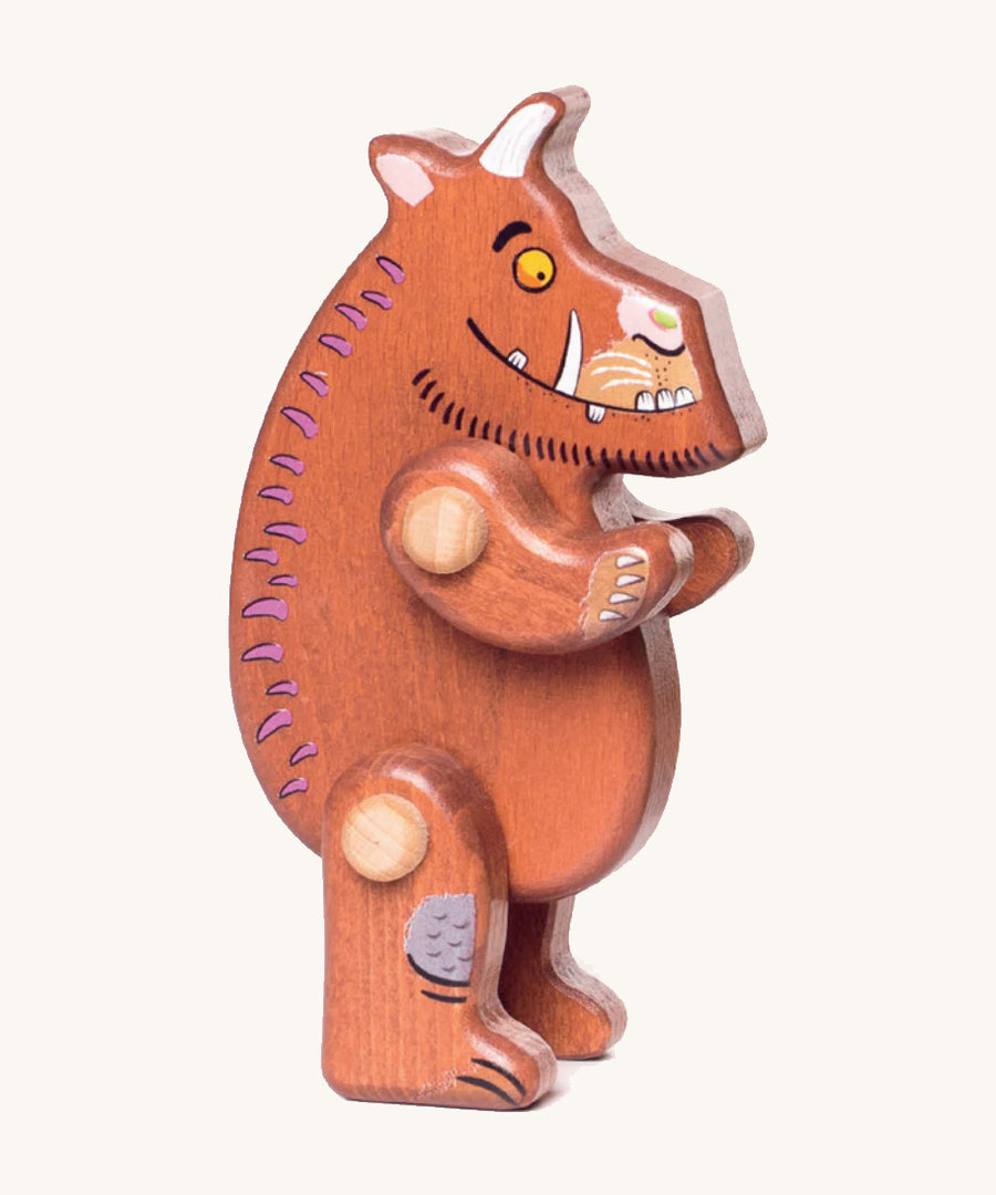 A wooden standing Gruffalo figure on a cream background