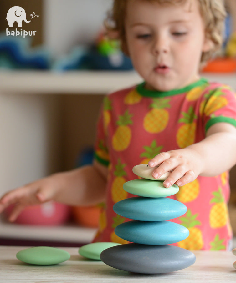 Build and stack with these wonderfully smooth and tactile 10 round wooden Pebbles by Bajo in shades of blue