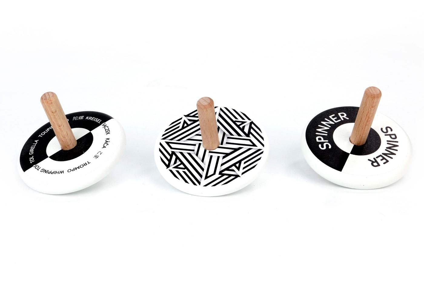 3 Bajo plastic-free black and white wooden spinning top toys on a white background