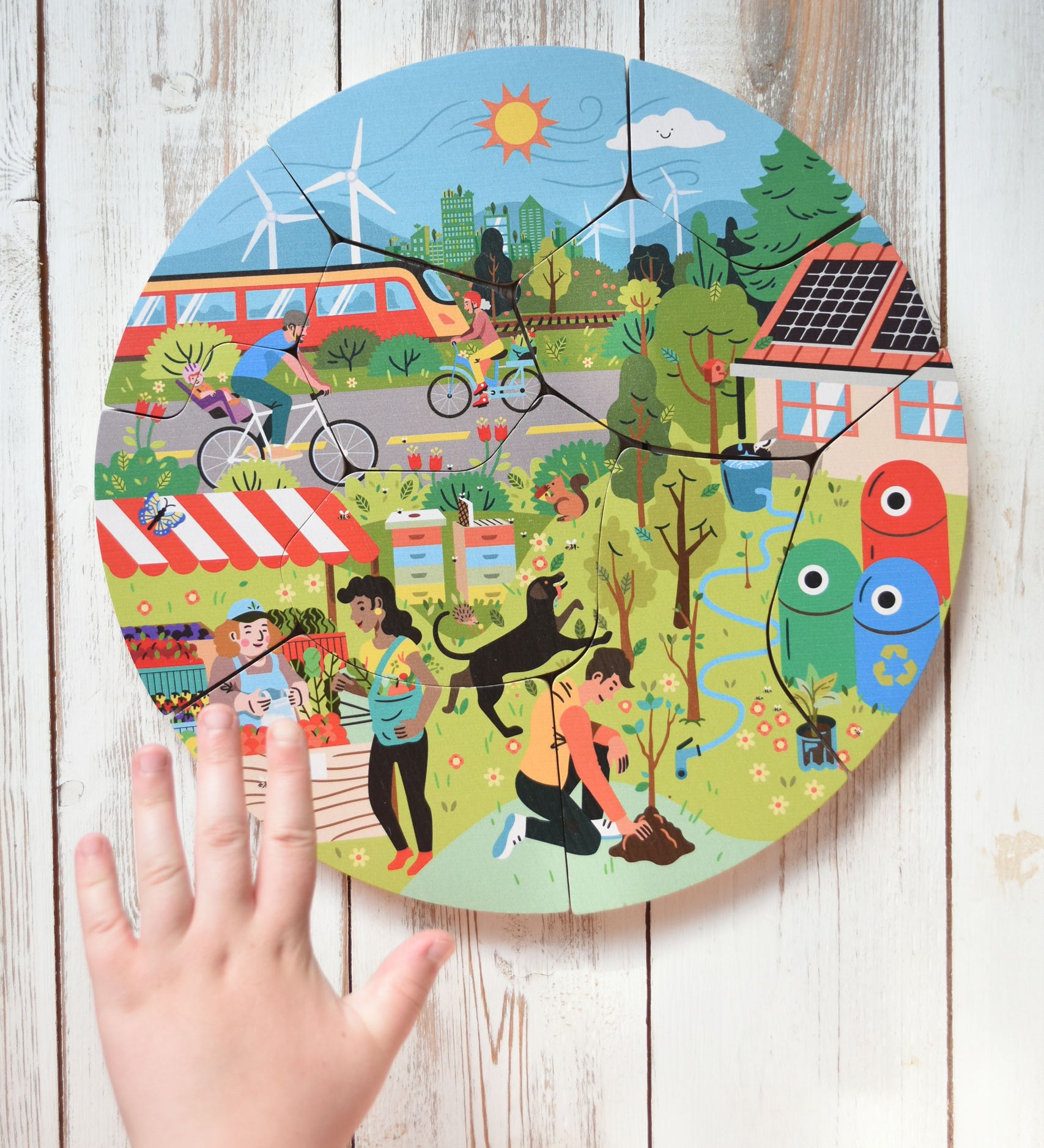 A child's hand hovering over the Bajo save our planet puzzle.