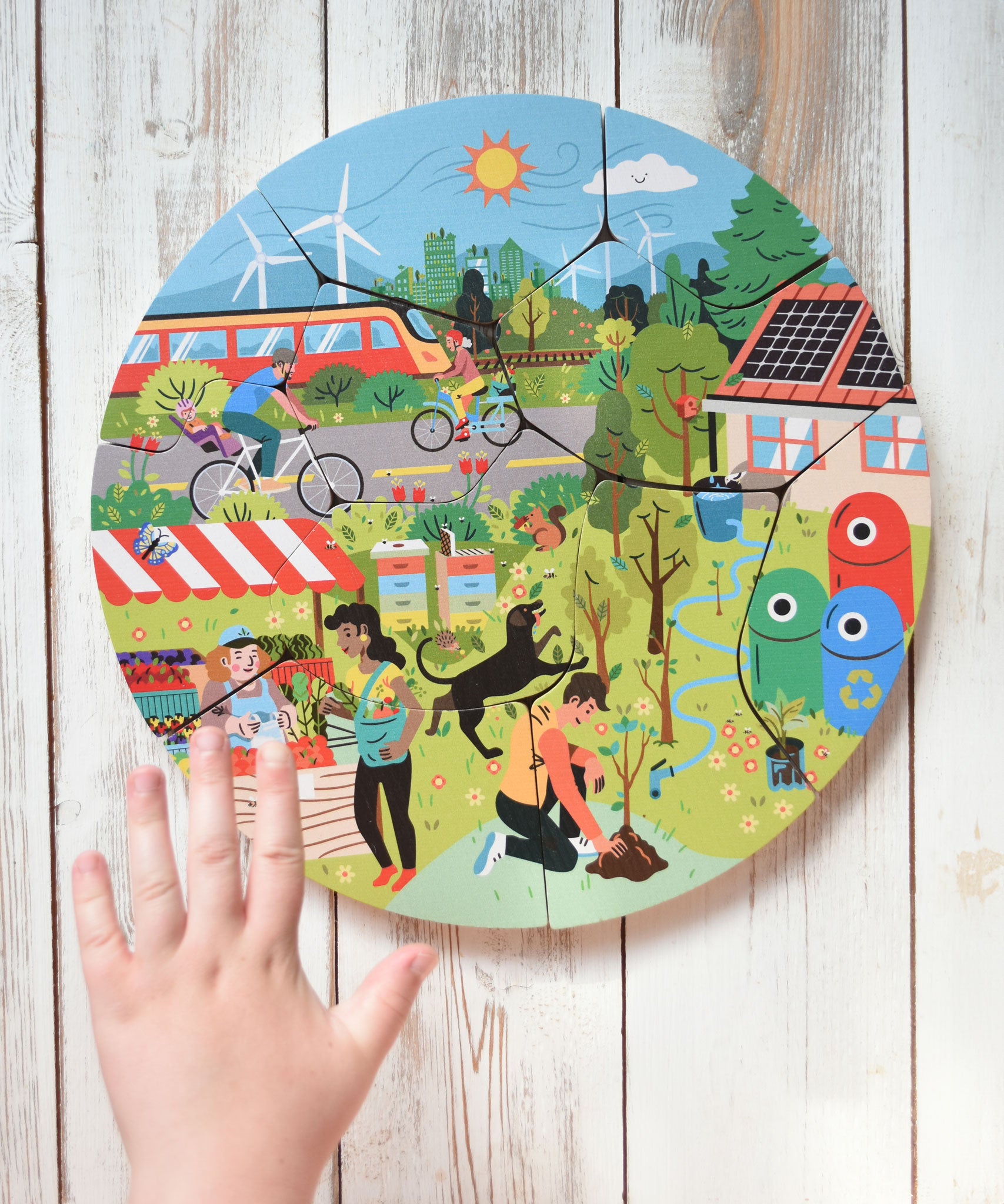 A child's hand hovering over the Bajo save our planet puzzle.