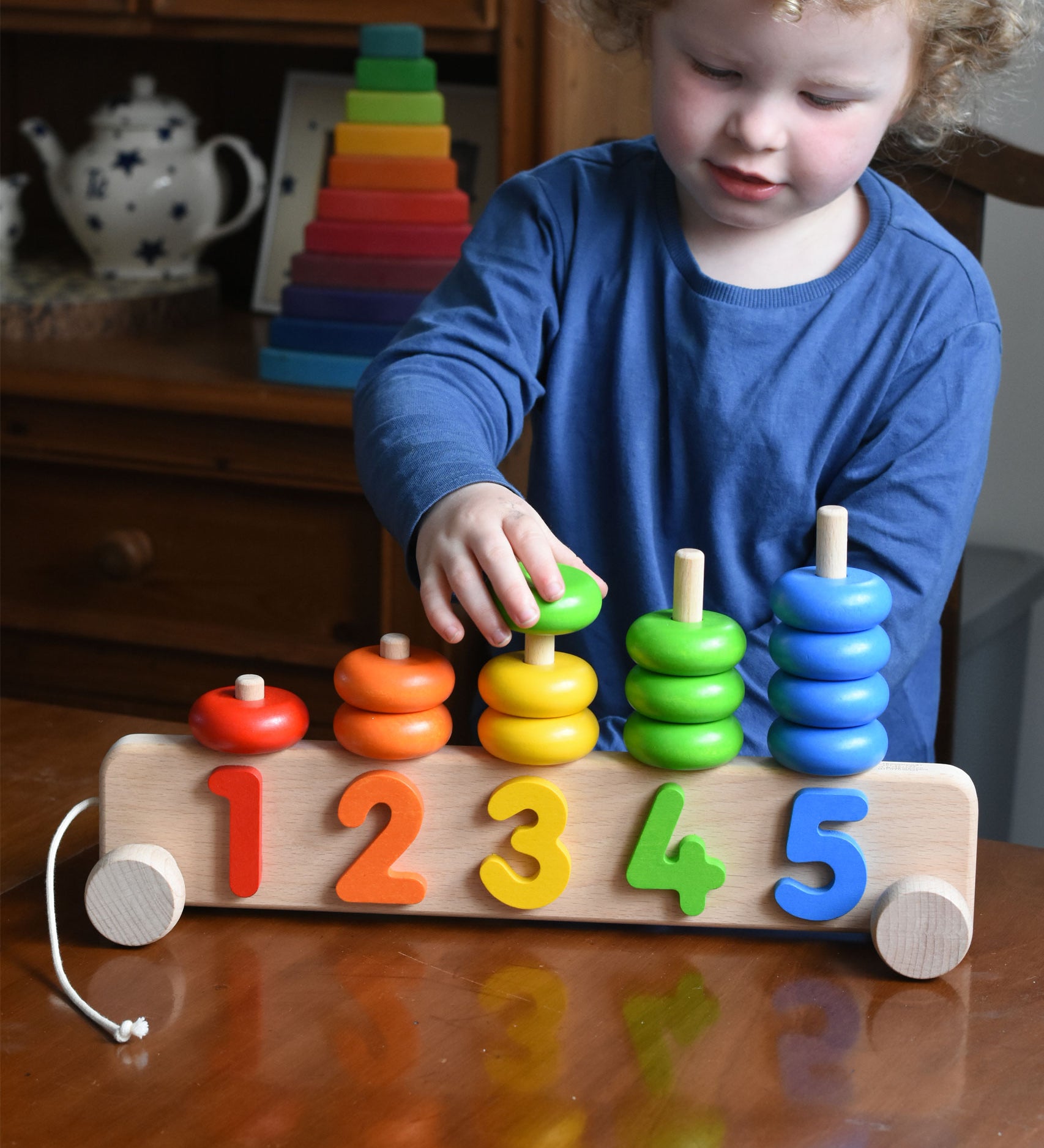 A child playing with a Bajo 1-5 pull along stacking toy