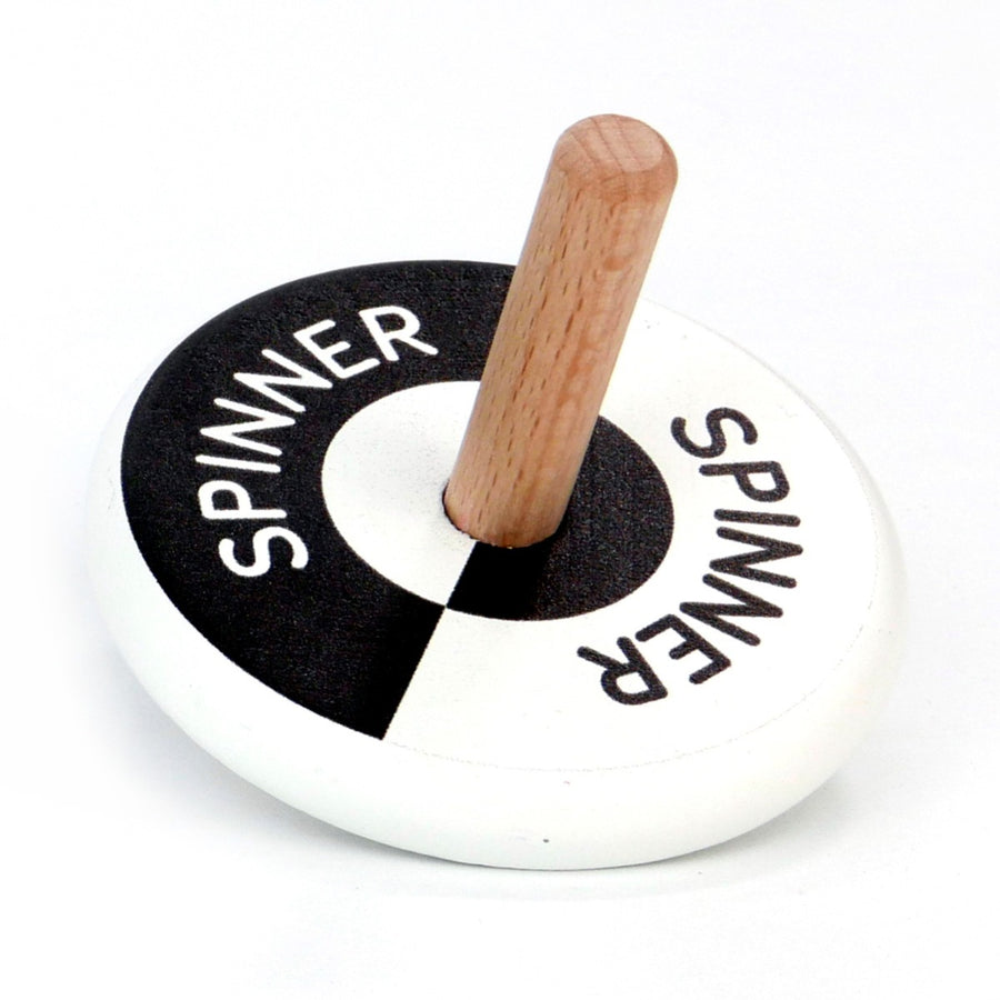 Bajo plastic-free wooden black and white spinning top on a white background