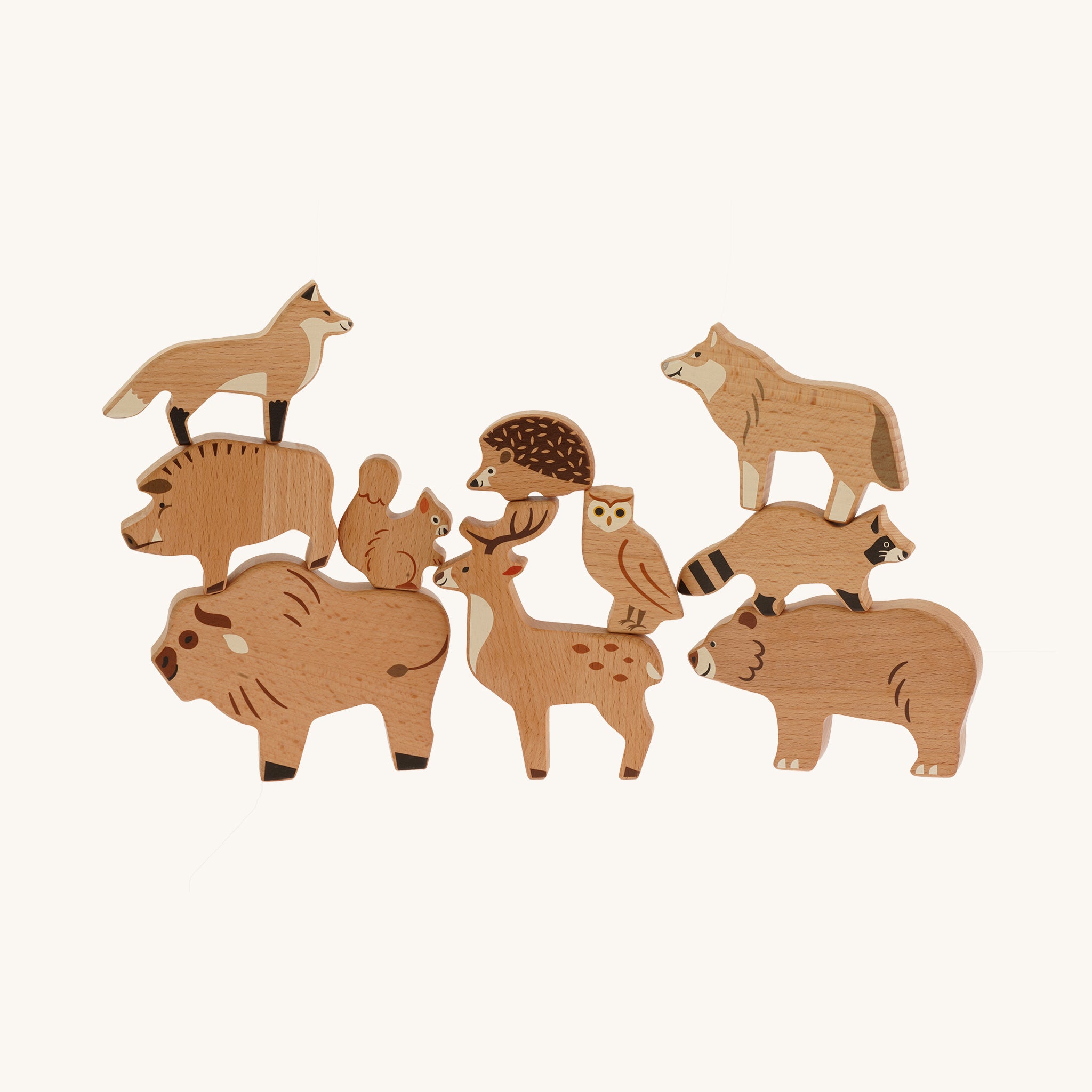 Bajo Wild Animals Forest Set, Wooden forest animal figures stacked on top of each other and include: Fox, Wolf, Bison, Squirrel, Deer, Hog, Owl, Raccoon, Bear, on a cream background