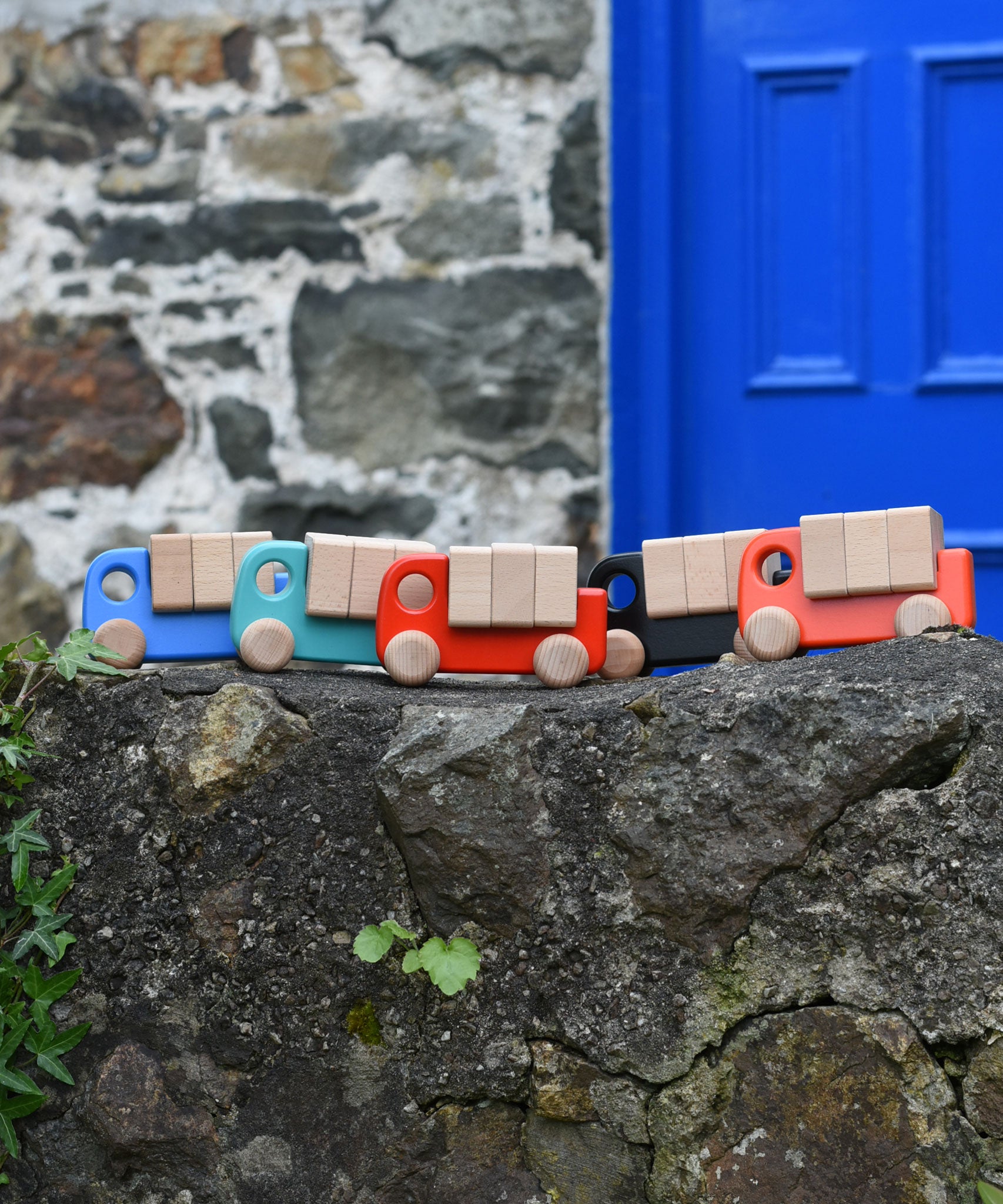 A collection of Bajo trucks with blocks placed on a stone wall 