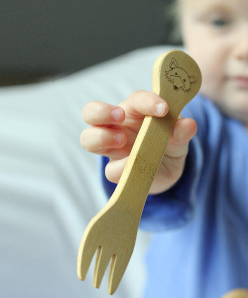 A child holding The Bambu Bamboo fork.