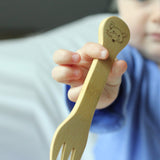 A child holding The Bambu Bamboo fork.