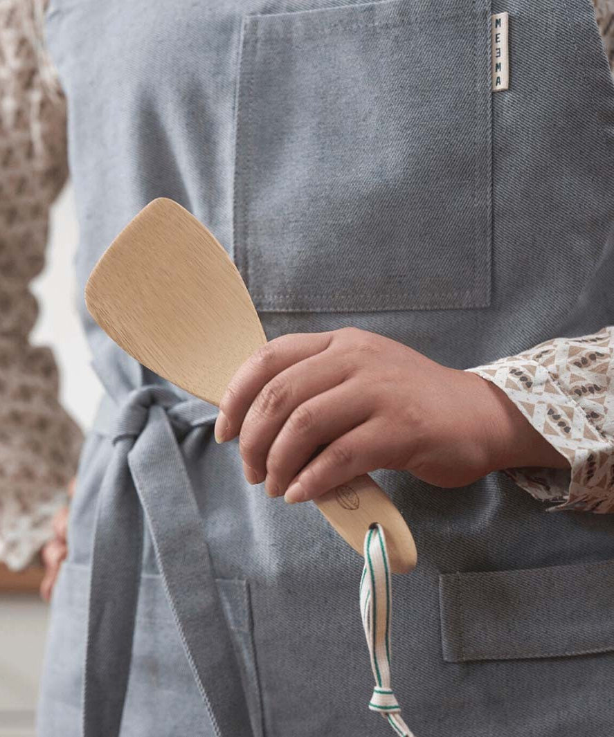 A Bambu Bamboo Rice Paddle  being held in a person's hand. 