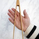 The Bambu small Tongs shown on a person's hand. 