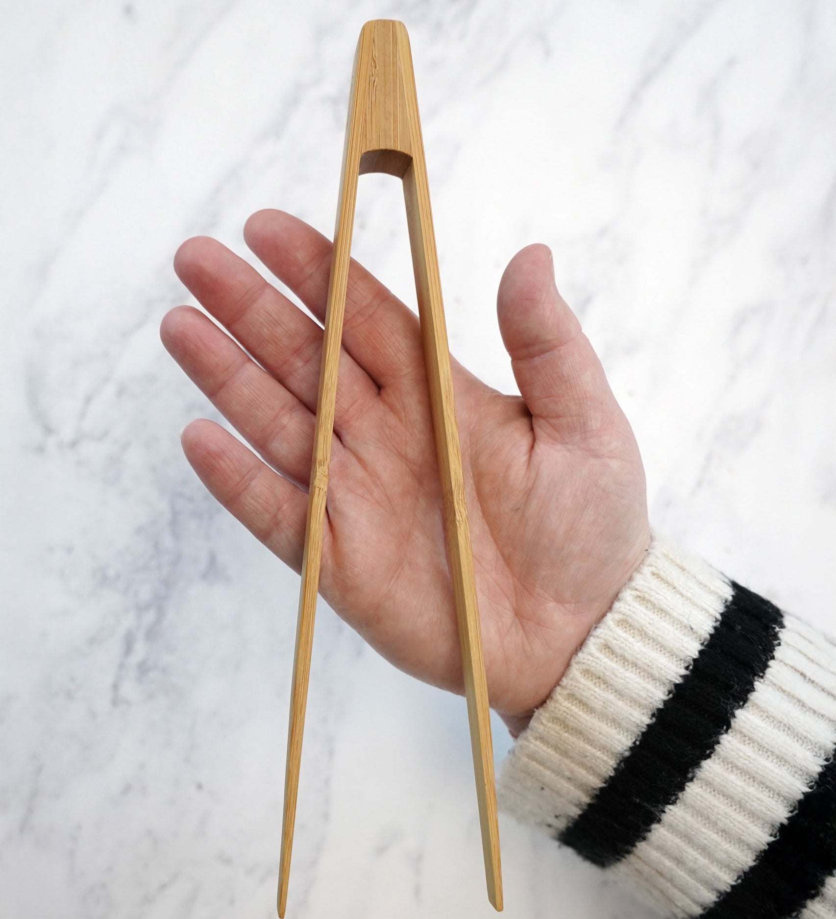 The Bambu small Tongs shown on a person's hand. 