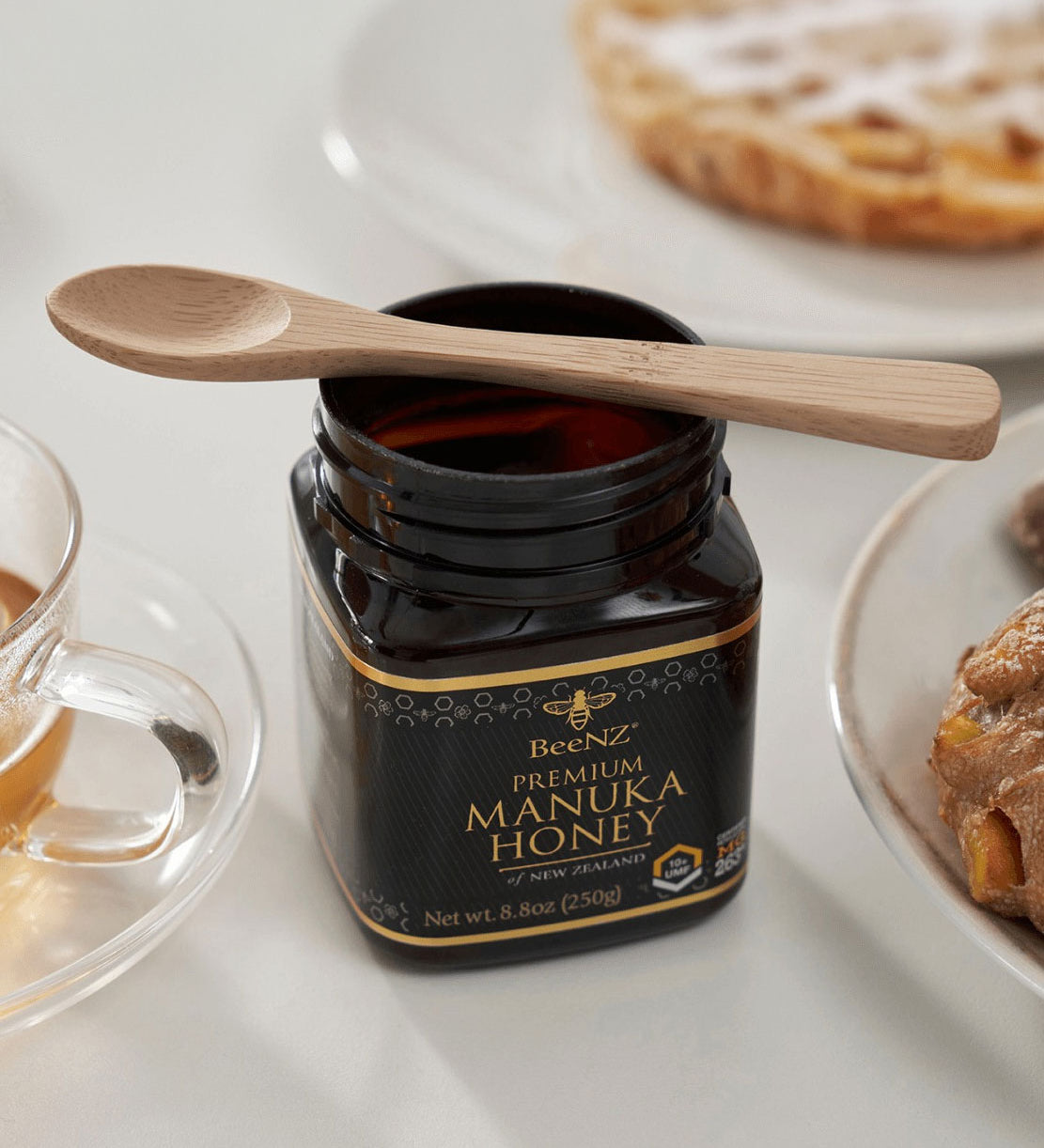 A Bambu Bamboo Tea Spoon resting on a jar of honey