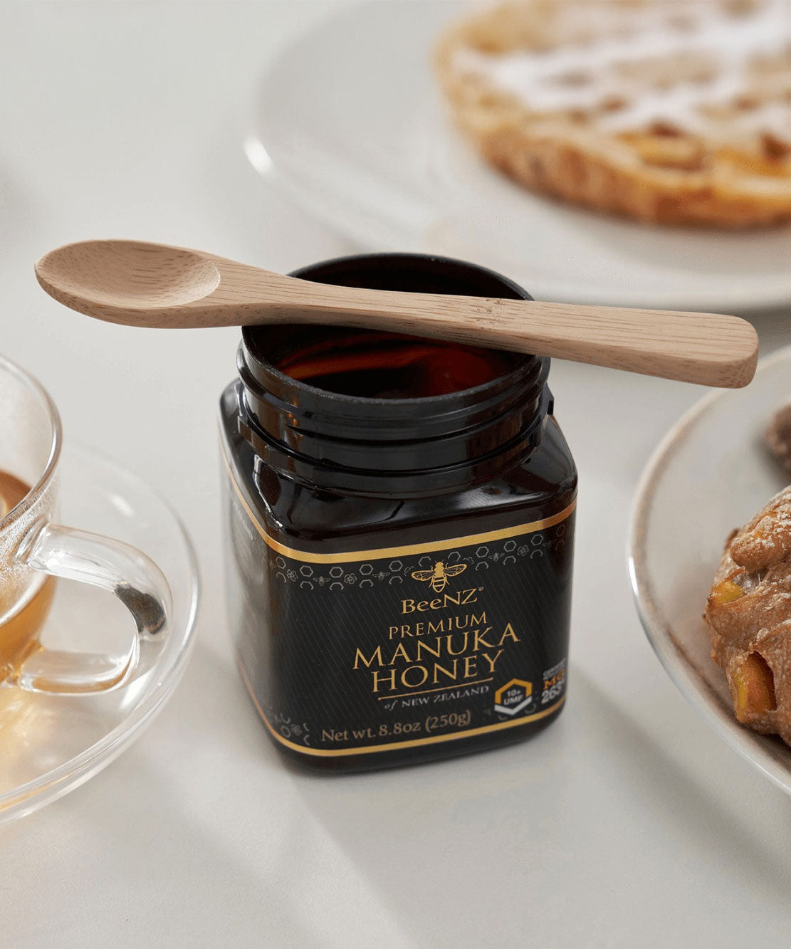 A Bambu Bamboo Tea Spoon resting on a jar of honey