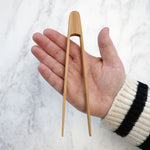 The Bambu Tiny Tongs shown on a person's hand. 