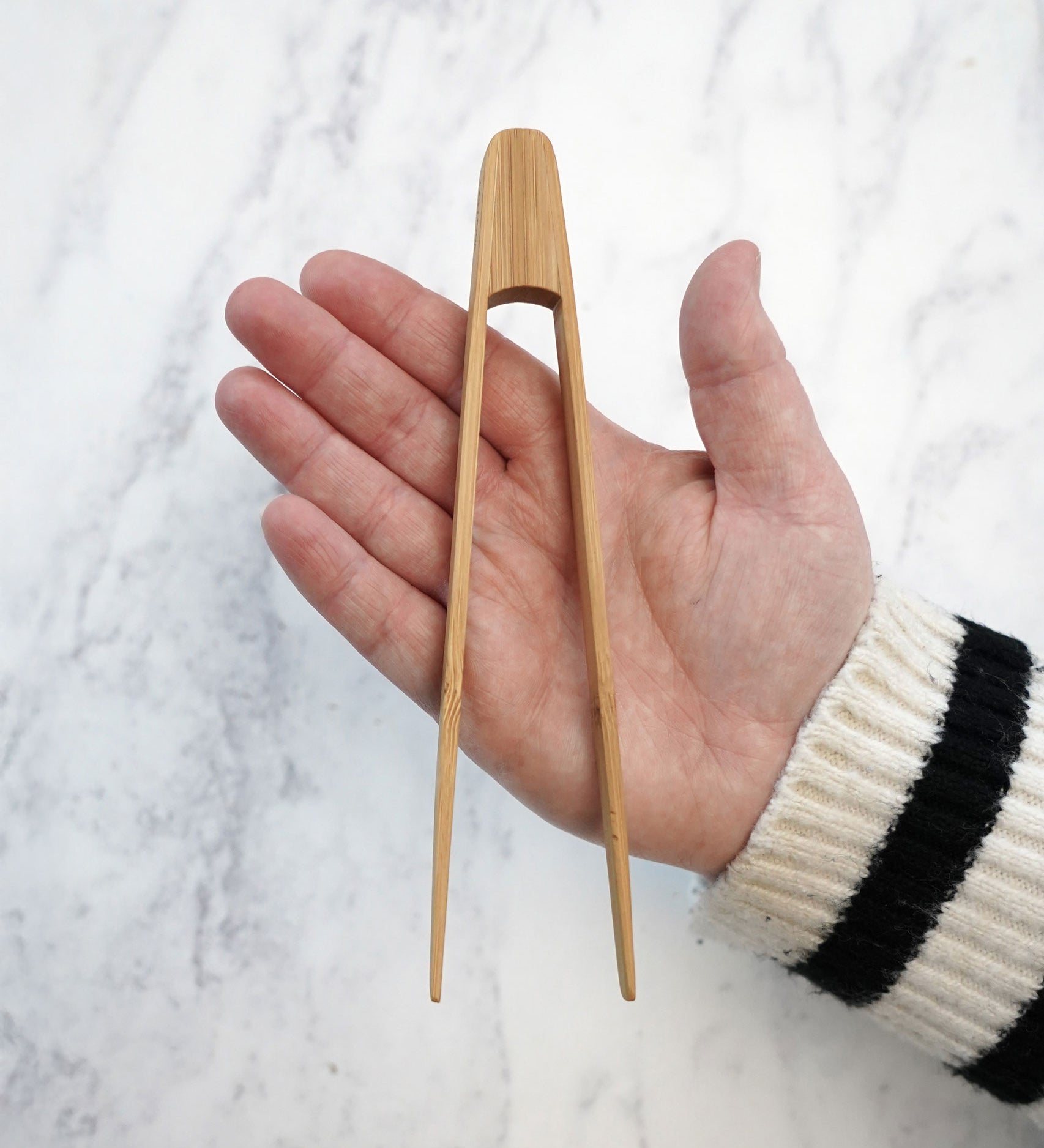 The Bambu Tiny Tongs shown on a person's hand. 