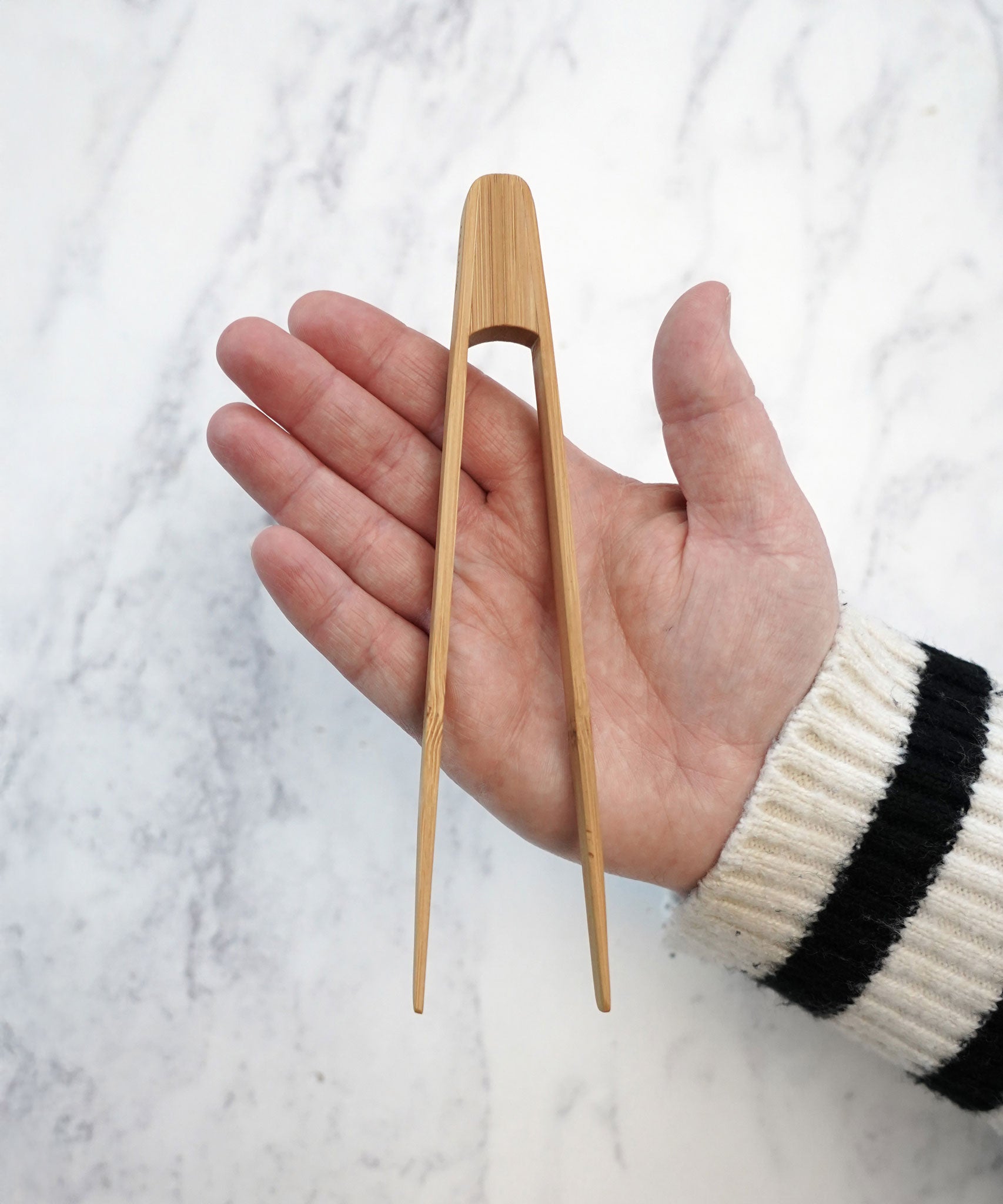 The Bambu Tiny Tongs shown on a person's hand. 