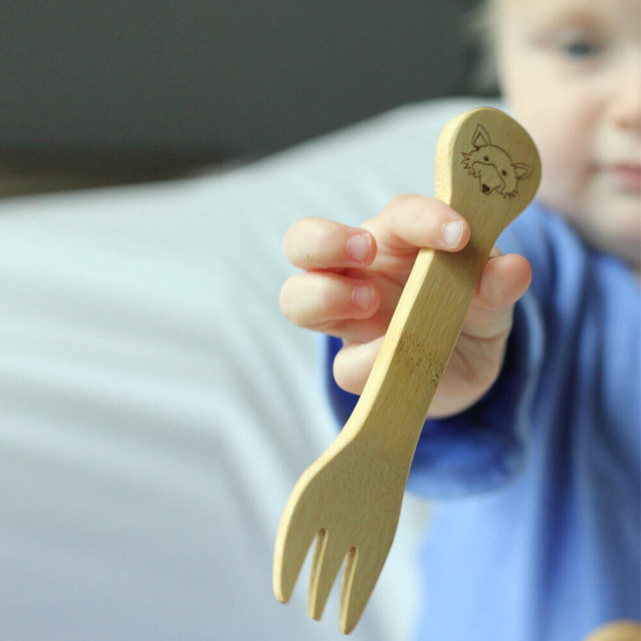 child holding the Bambu bamboo fork