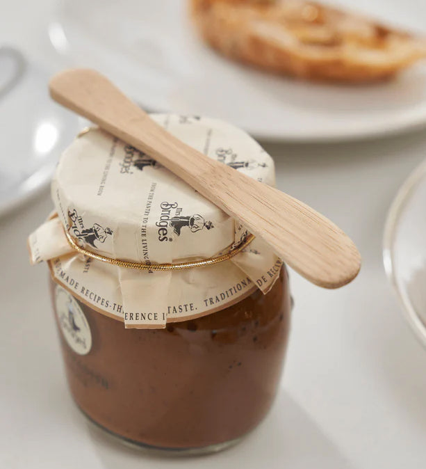 A Bambu bamboo Mini Spreader placed on top of a jam jar. 