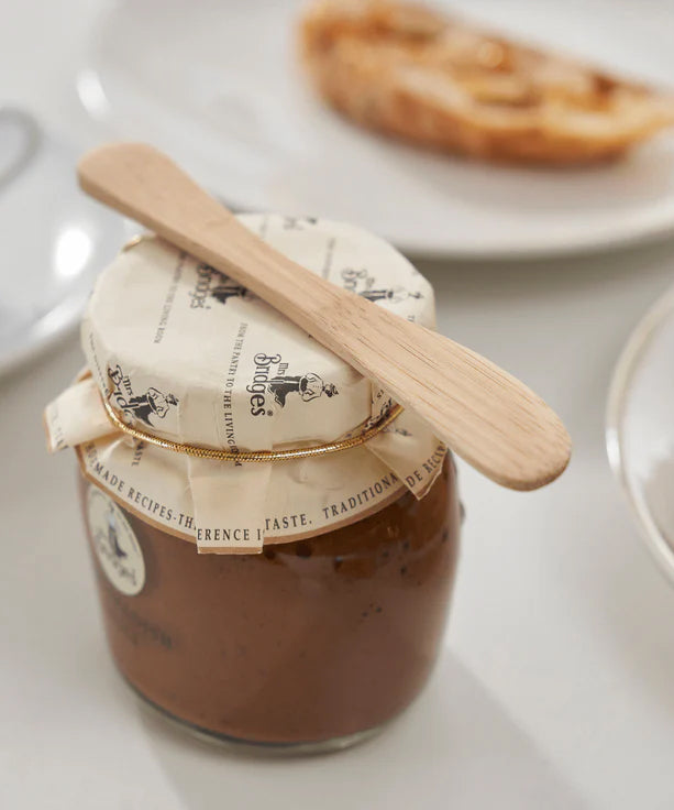 A Bambu bamboo Mini Spreader placed on top of a jam jar. 