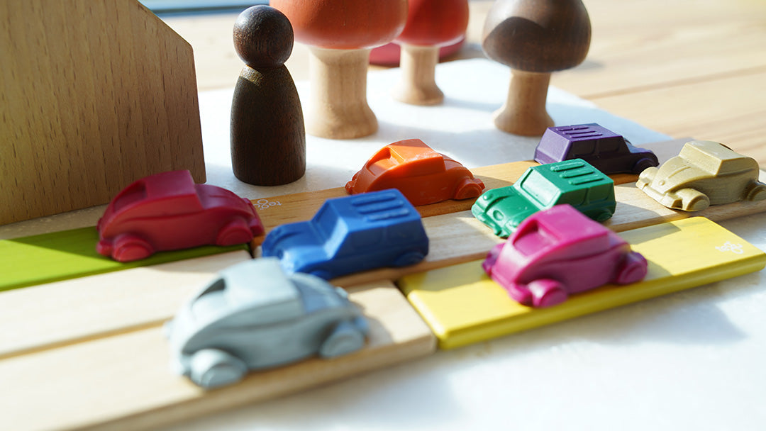 Bee Crayative car shaped crayons posed on a toy road