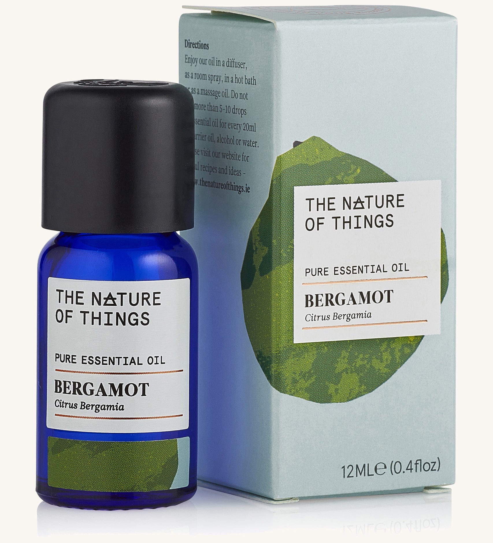 Bergamot pure essential oil in a blue glass bottle in front of a decorative blue cardboard box.