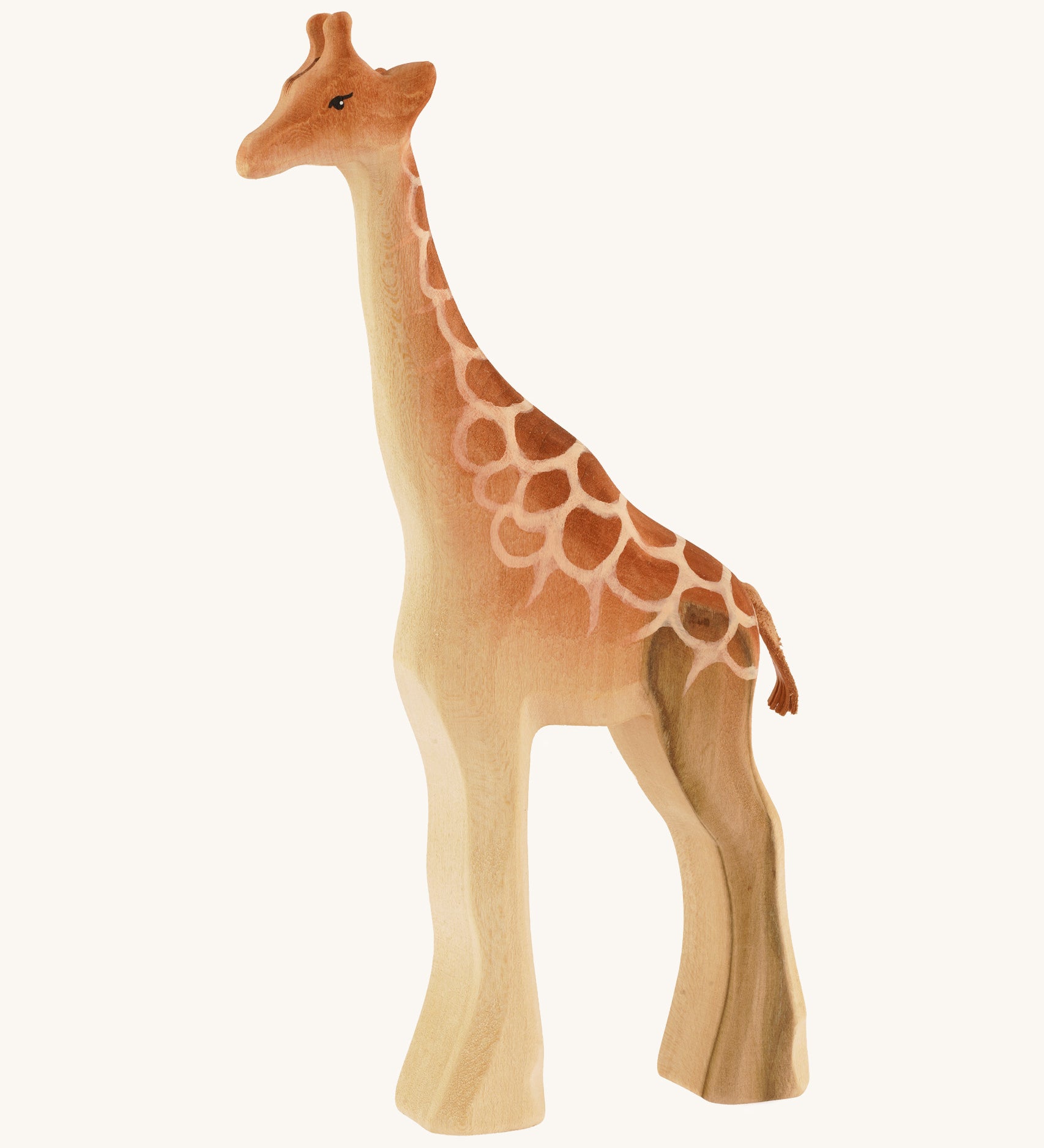 Male wooden standing giraffe on a cream background