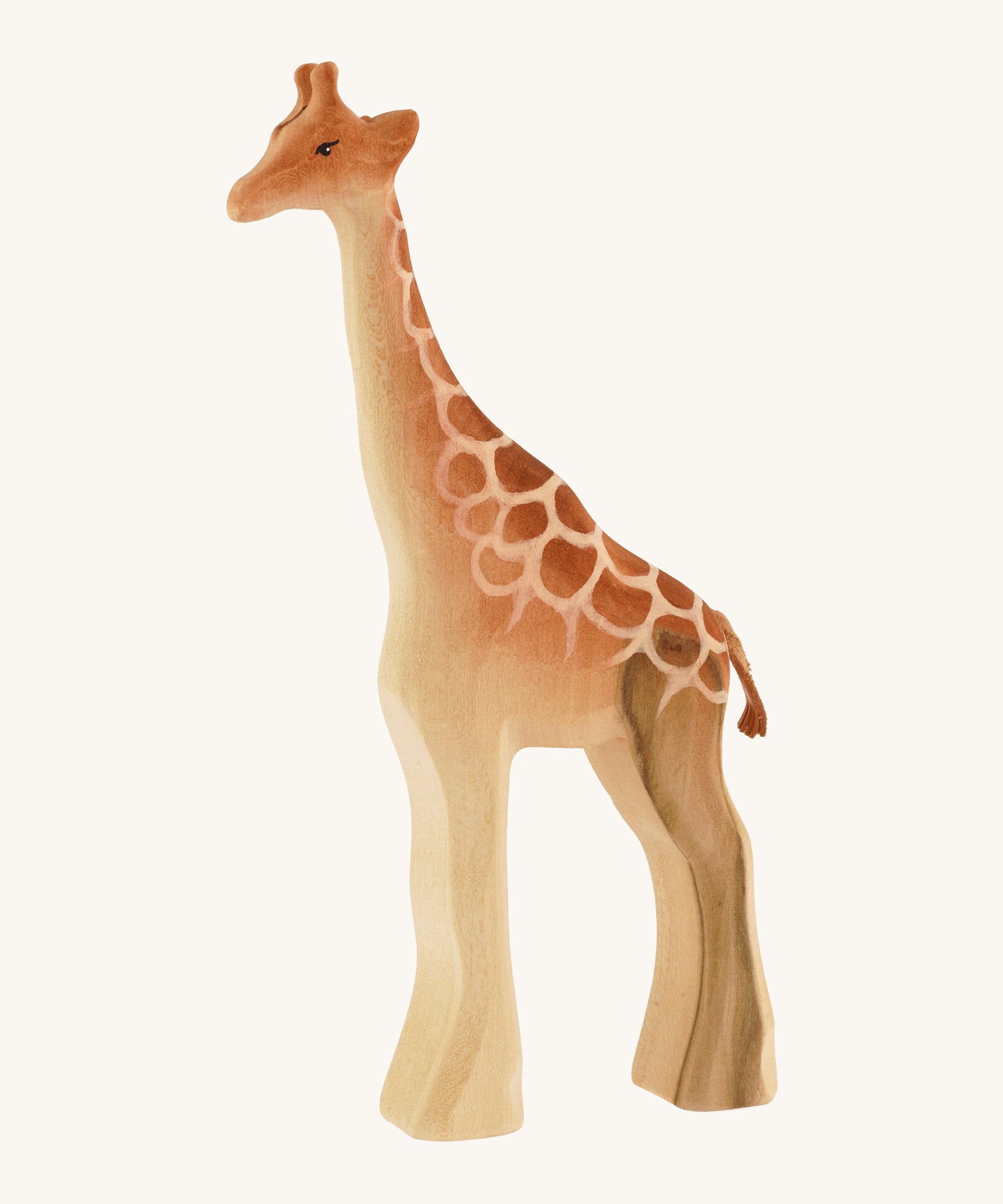 Male wooden standing giraffe on a cream background