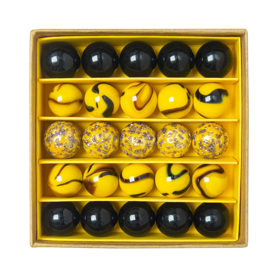 Close up of the Billes & Co recycled glass Bee Happy marbles in their box on a white background