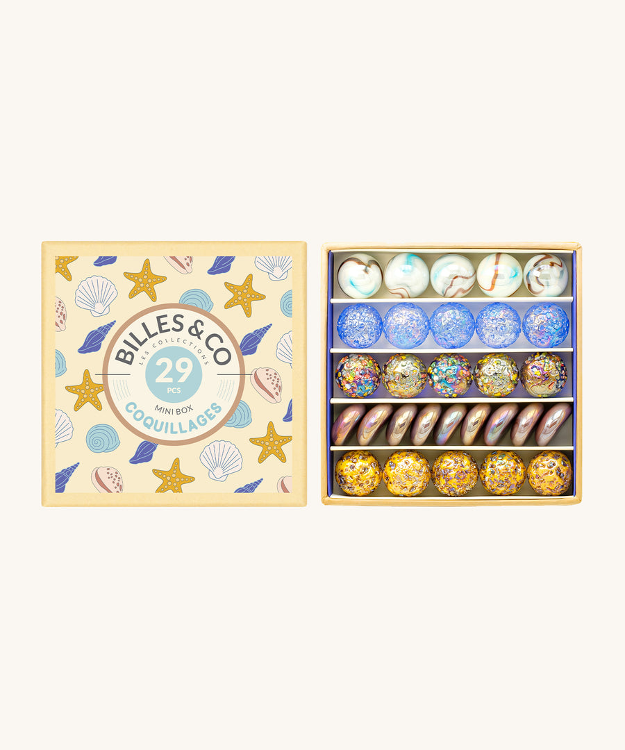 Billes & Co Seashells Glass Marbles Mini Box - 29 Pack. Flat and round marbles in a smooth or textured finish, with glossy seashell and beach colours