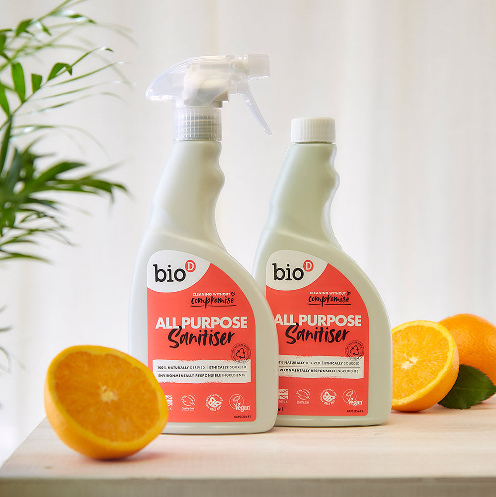 Bio-D spray bottle and refill bottles of all purpose sanitisers surrounded by oranges