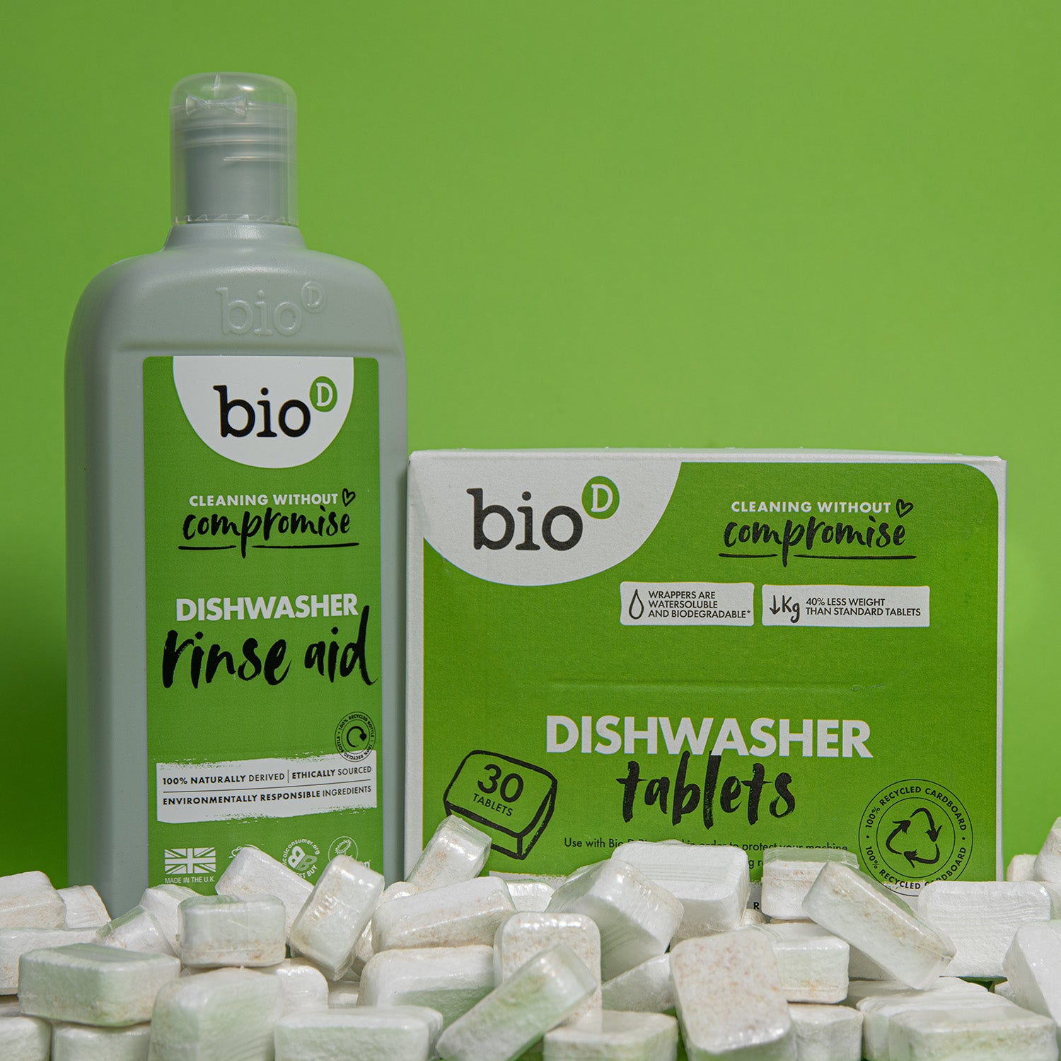 Box of Bio D eco friendly dishwasher tablets and bottle of Bio-D rinse aid on a green background