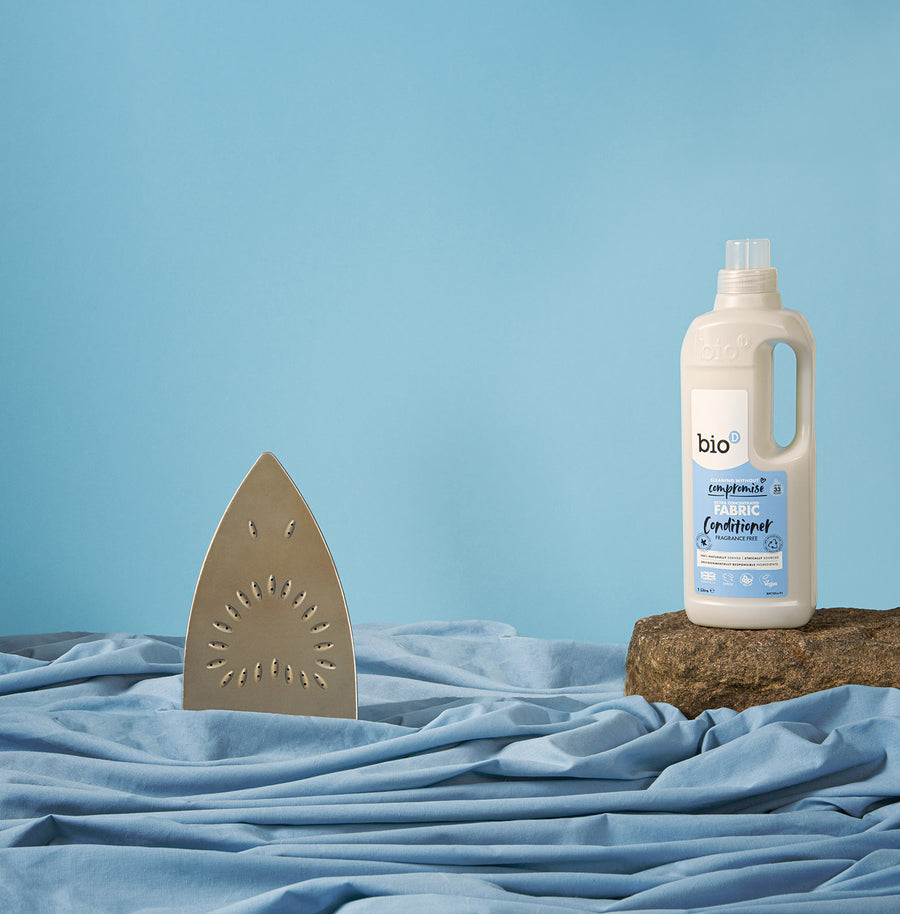 Bio-D fragrance free fabric conditioner 1 litre bottle on a blue back ground with a pretend iron shark in blue fabric water