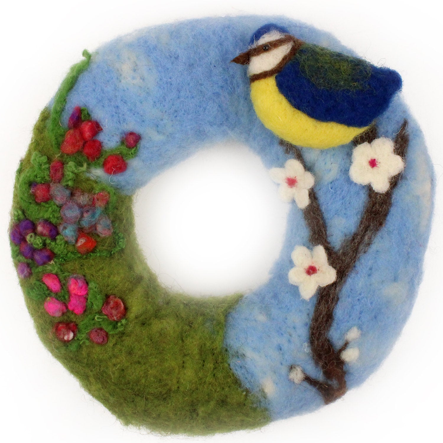 A close up of a completed The Makerss - Blossom and Blue Tit Wreath Needle Felt Kit. A beautifully decorated wreath with a colourful Blue Tit stood on a cherry blossom tree