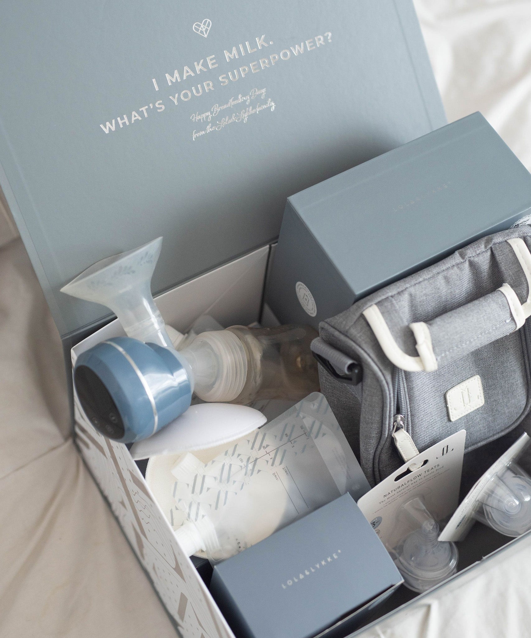 The contents of the Lola & Lykke Breastfeeding Starter Kit, shown inside its box