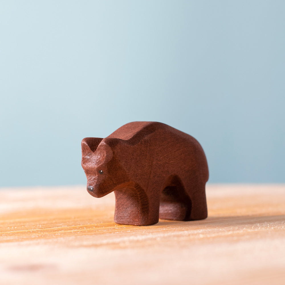 Close up of the Bumbu childrens wooden bear cub toy figure on a wooden worktop