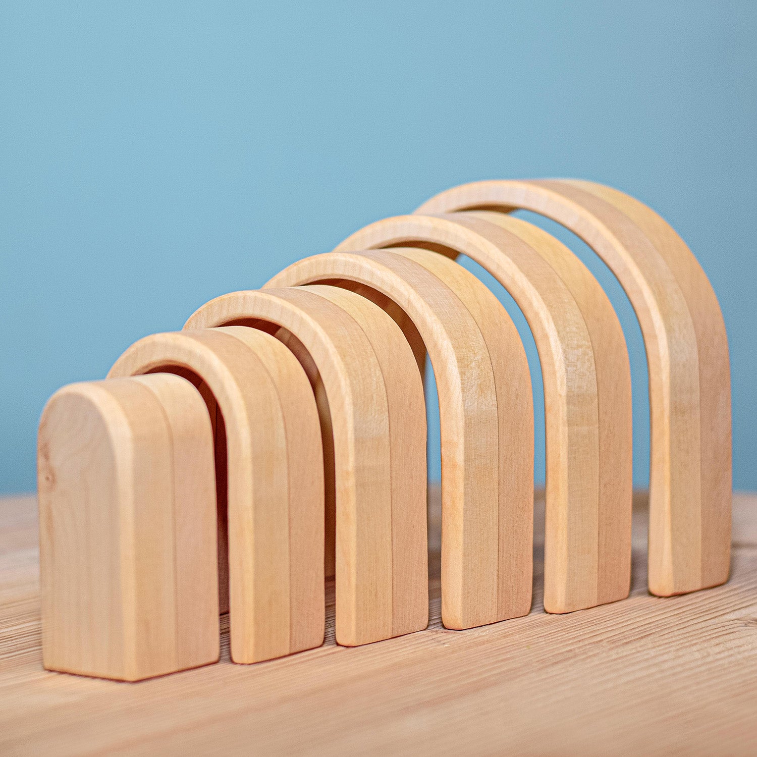 Bumbu Natural Wooden Stacking Arches. The arches are paired with trees and a unicorn.