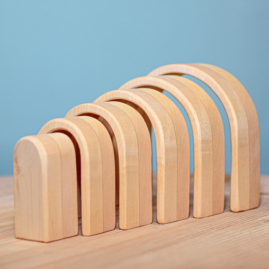 Bumbu Natural Wooden Stacking Arches. The arches are paired with trees and a unicorn.