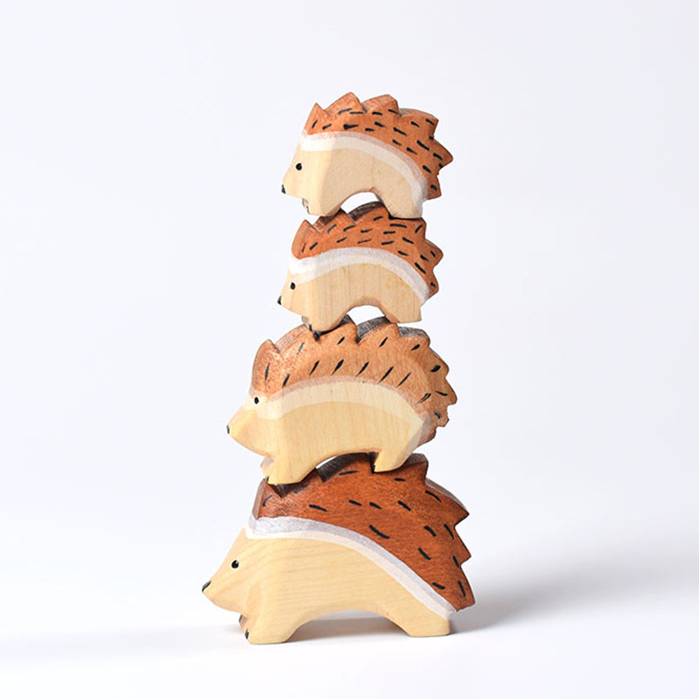 Bumbu sustainable wooden waldorf hedgehog figures stacked in a tower on a white background