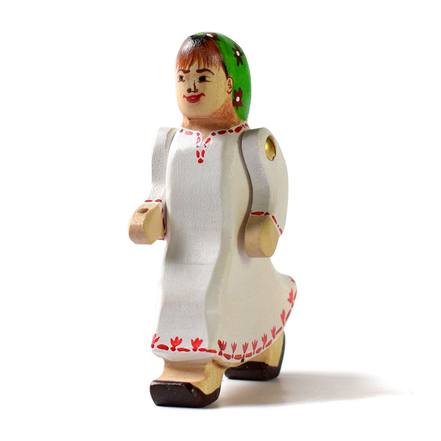 Close up of handmade wooden Bumbu lady figure on a white background