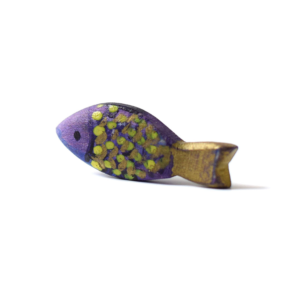 Close up of the eco-friendly wooden fish from the Bumbu Lake puzzle on a white background