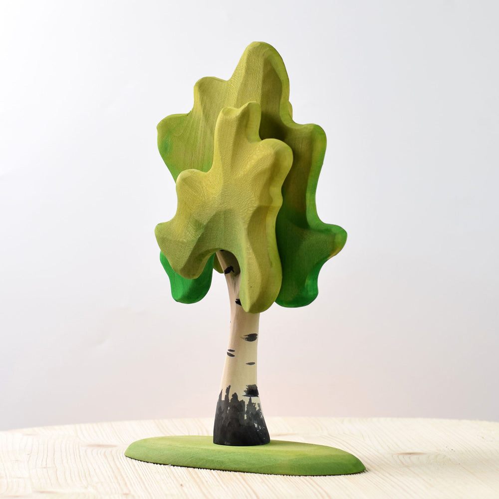 Close up of the Bumbu plastic free medium birch tree toy on a wooden table