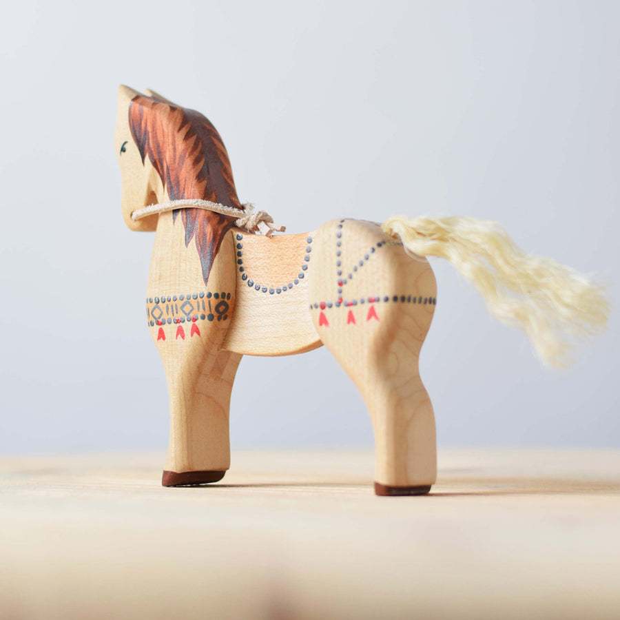 Bumbu plastic-free wooden steed toy on a wooden worktop