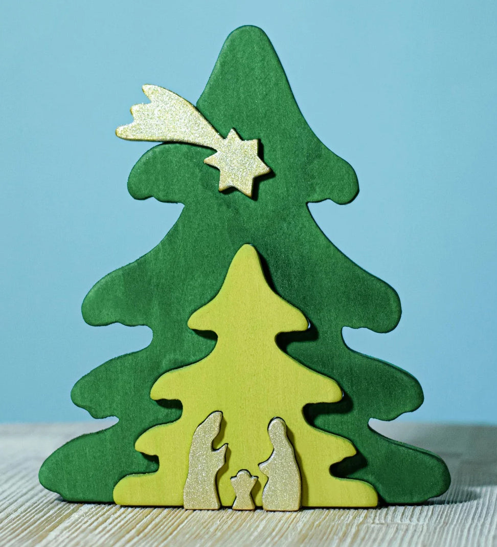 A Bumbu Christmas Tree Nativity Puzzle in the Gold colour way placed on a wooden surface. 