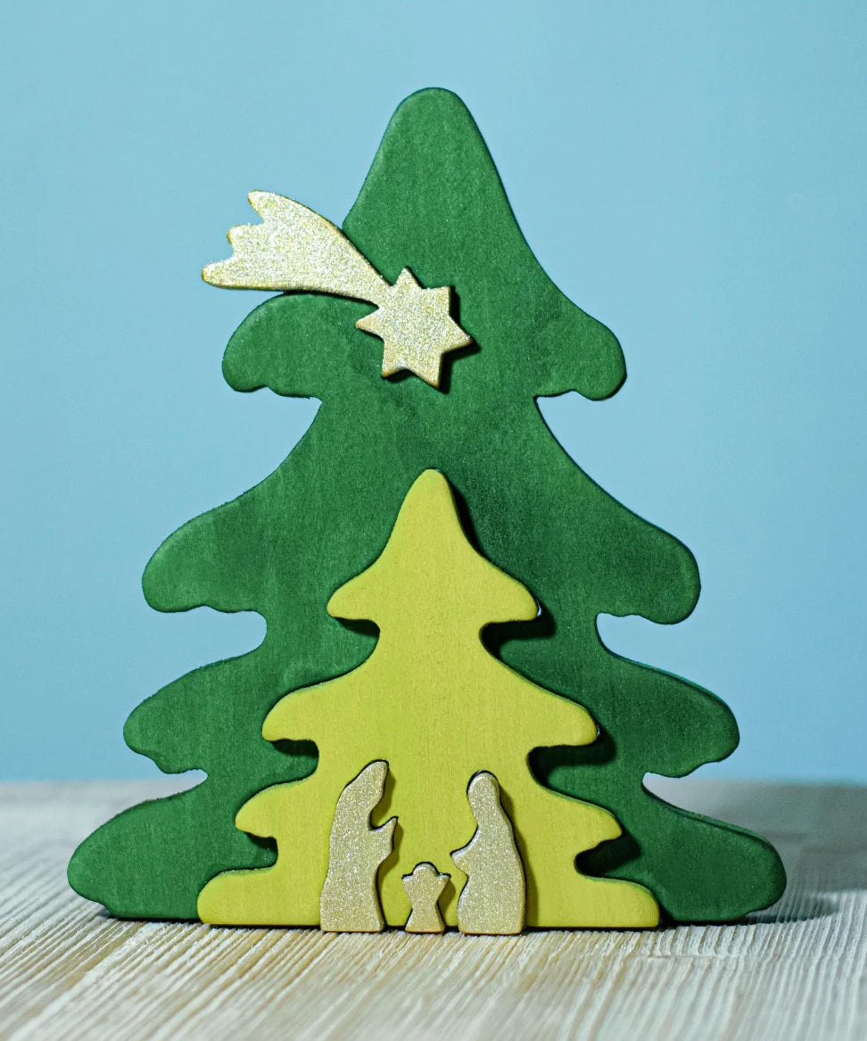 A Bumbu Christmas Tree Nativity Puzzle in the Gold colour way placed on a wooden surface. 