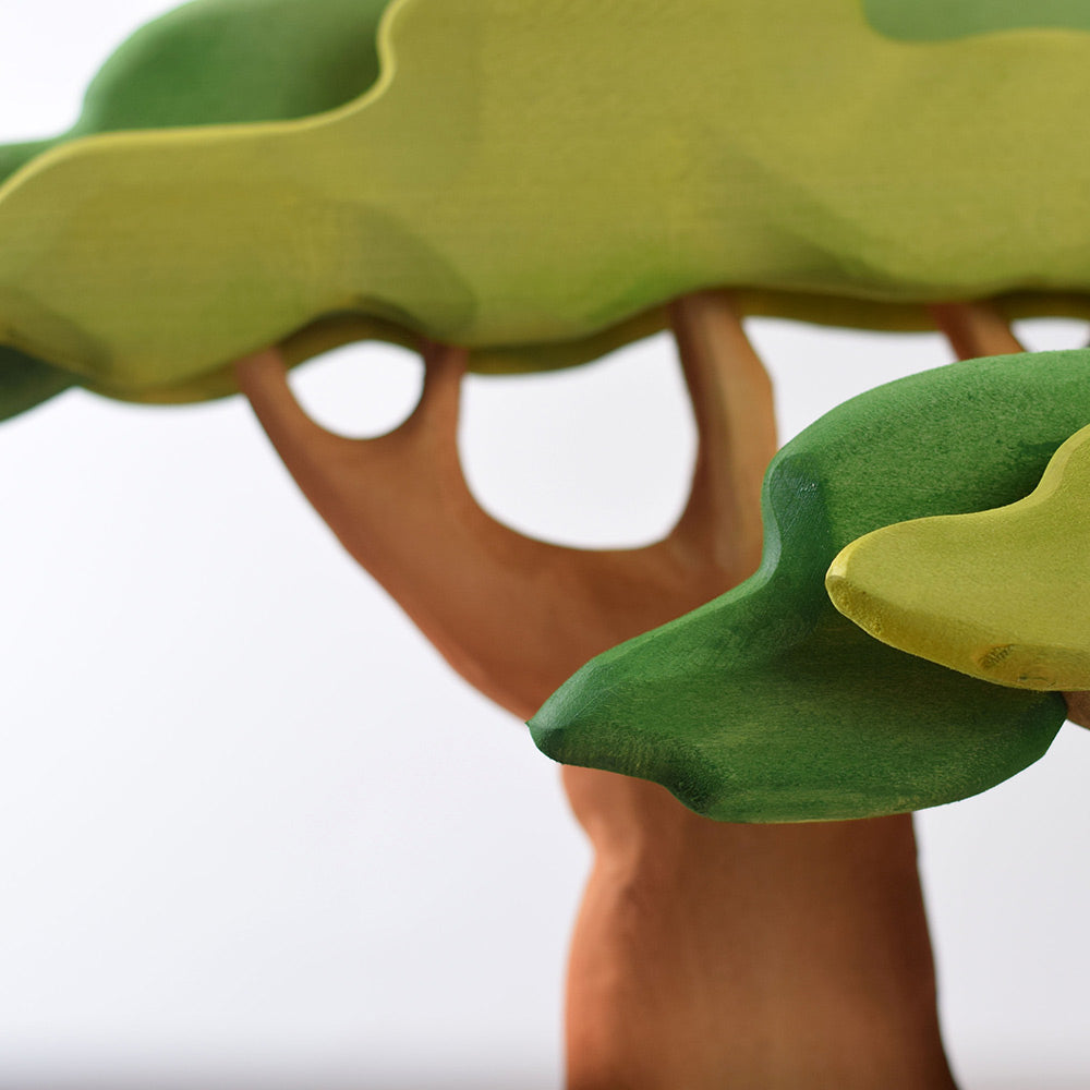 Close up of the Bumbu eco-friendly wooden Baobab tree leaves in front of a grey background