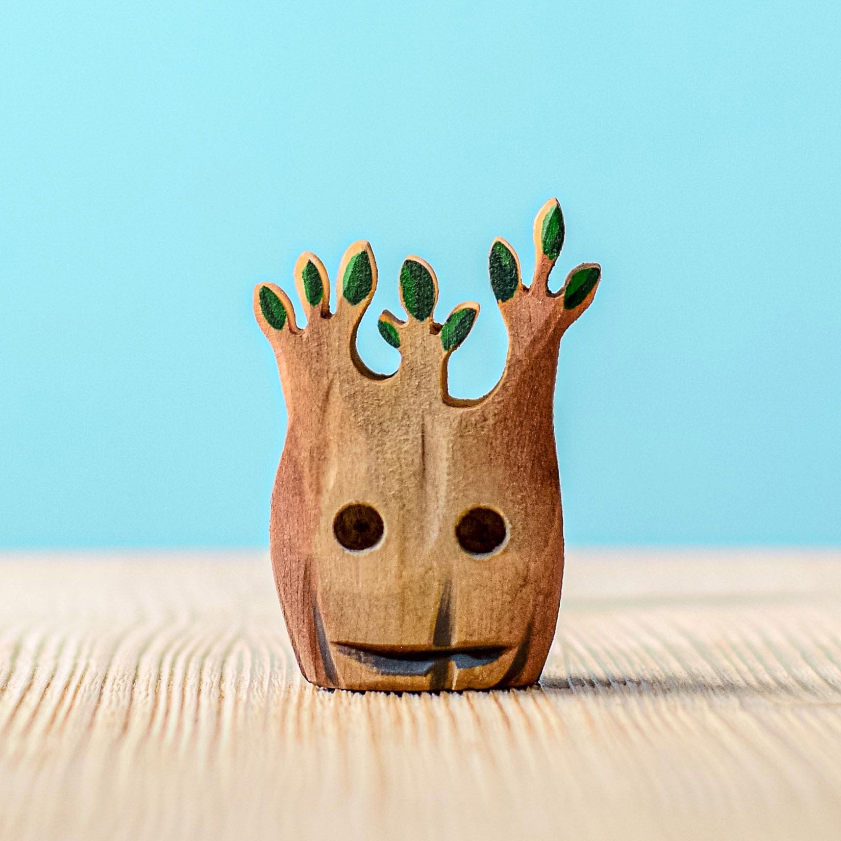 Bumbu Small Wooden Spooky Halloween Tree on a blue background.