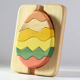 Bumbu sustainable wooden egg puzzle stood up on a grey background