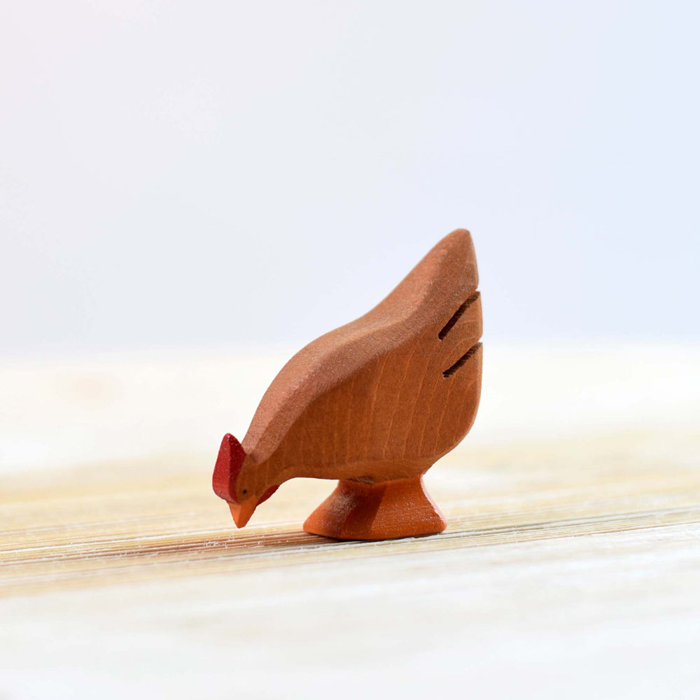 Bumbu handmade brown wooden hen toy on a wooden worktop