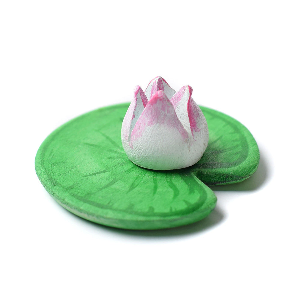 Close up of Bumbu eco-friendly wooden lily pad on a white background