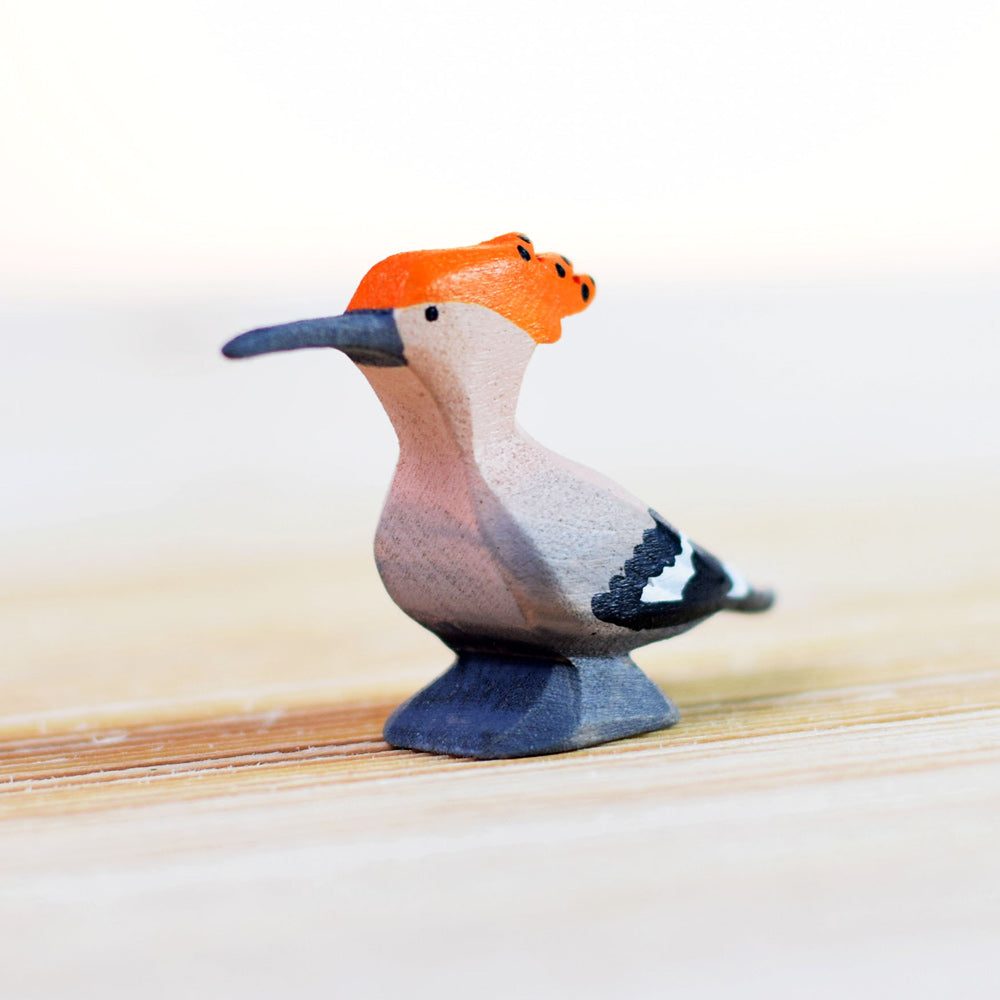 Close up of the Bumbu handmade wooden hoopoe bird figure on a wooden background