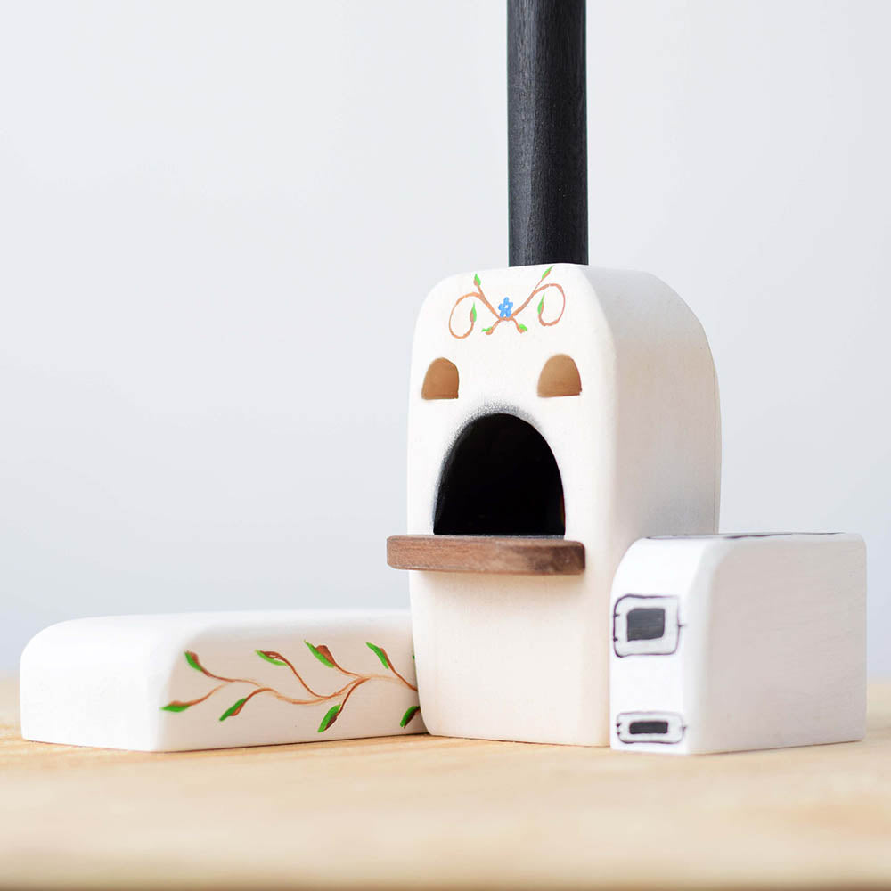 stove and bench toy set on a wooden worktop